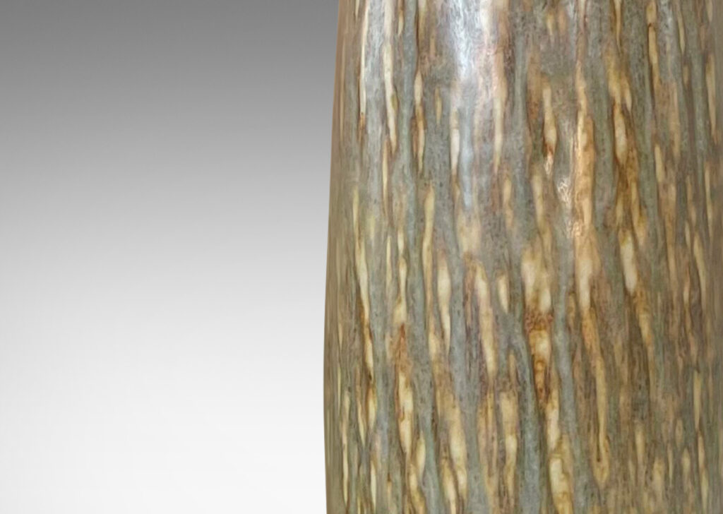 Gallery BAC tall swelling column forms with carved rustic texture and flowing brown glaze