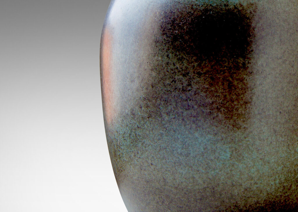 Gallery BAC tapered ovoid body with attenuated neck and reveal foot, crafted in stoneware glazed in an atmospherically applied gray over a cornflower blue