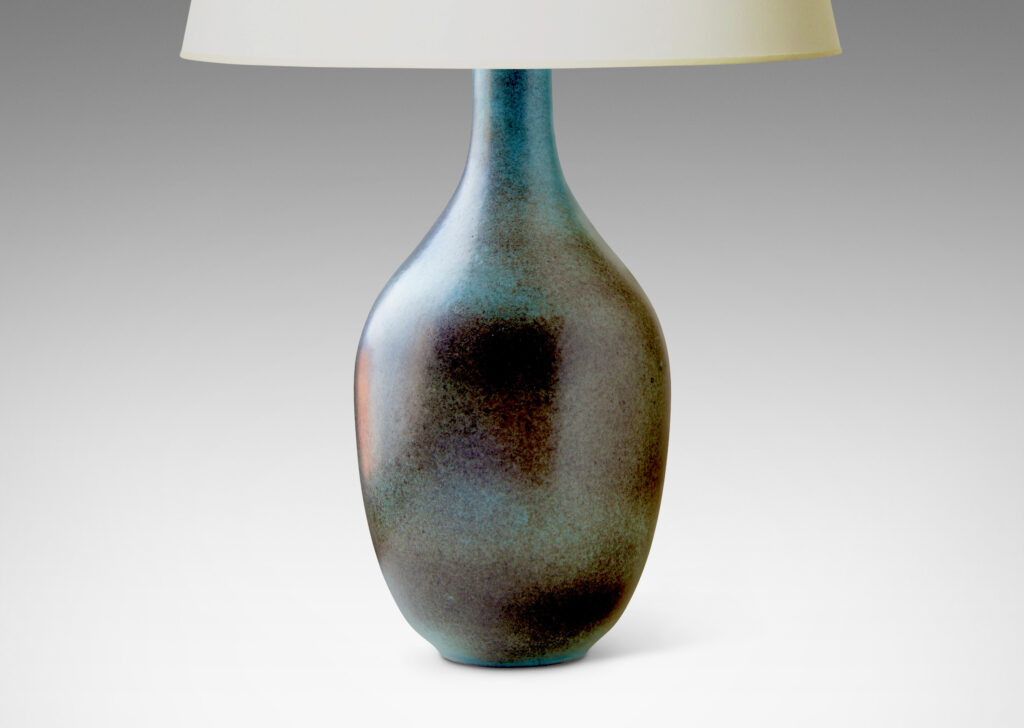 Gallery BAC tapered ovoid body with attenuated neck and reveal foot, crafted in stoneware glazed in an atmospherically applied gray over a cornflower blue