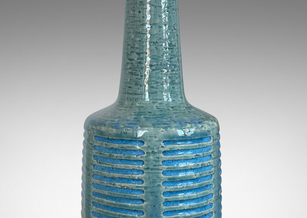 Gallery BAC cylindrical form with grid of carved strikes and tall conical neck, glazed in a pale turquoise