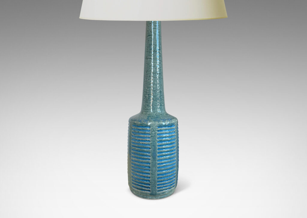 Gallery BAC cylindrical form with grid of carved strikes and tall conical neck, glazed in a pale turquoise