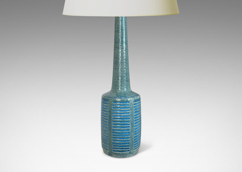 Gallery BAC cylindrical form with grid of carved strikes and tall conical neck, glazed in a pale turquoise