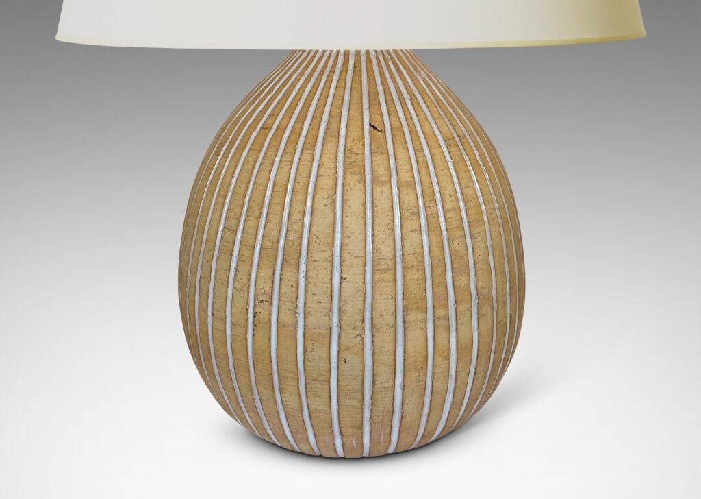 Gallery BAC bulbous forms in an unglazed sandy tone, with carved vertical pinstripes glazed gloss white