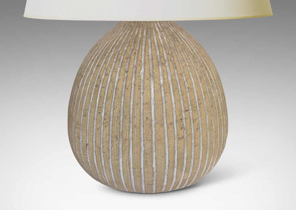 Gallery BAC bulbous forms in an unglazed sandy tone, with carved vertical pinstripes glazed gloss white