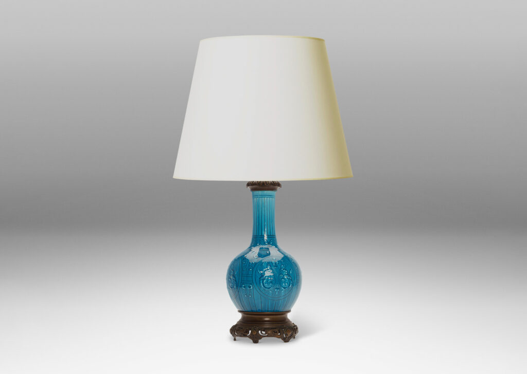 Gallery BAC globe form with tall neck and carved medallion pattern glazed in a brilliant azure