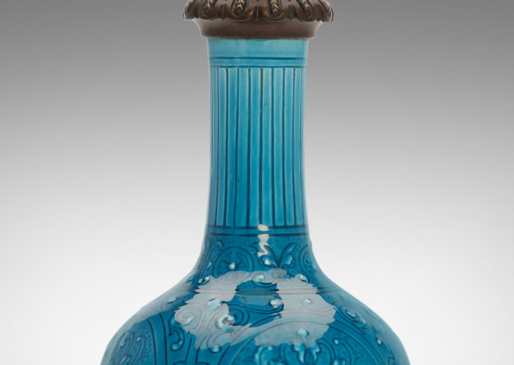 Gallery BAC globe form with tall neck and carved medallion pattern glazed in a brilliant azure