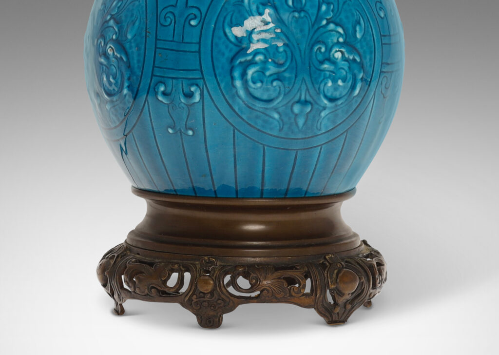 Gallery BAC globe form with tall neck and carved medallion pattern glazed in a brilliant azure