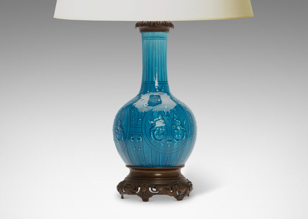 Gallery BAC globe form with tall neck and carved medallion pattern glazed in a brilliant azure