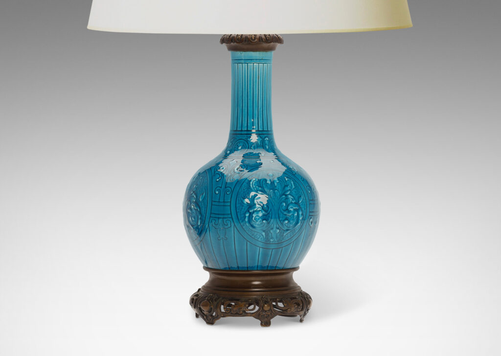 Gallery BAC globe form with tall neck and carved medallion pattern glazed in a brilliant azure