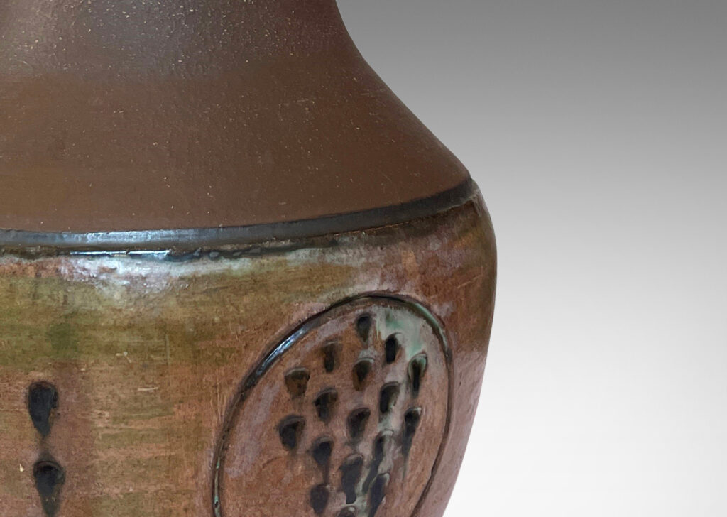 Gallery BAC drum form with carved geometric decorations and a conical neck, glazed in matte brown and eggshell finish taupe and brown