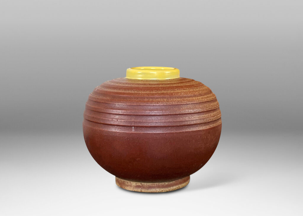 Gallery BAC globe forms with carved pinstripe banding, glazed in brown and yellow