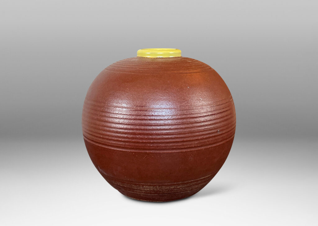 Gallery BAC globe forms with carved pinstripe banding, glazed in brown and yellow