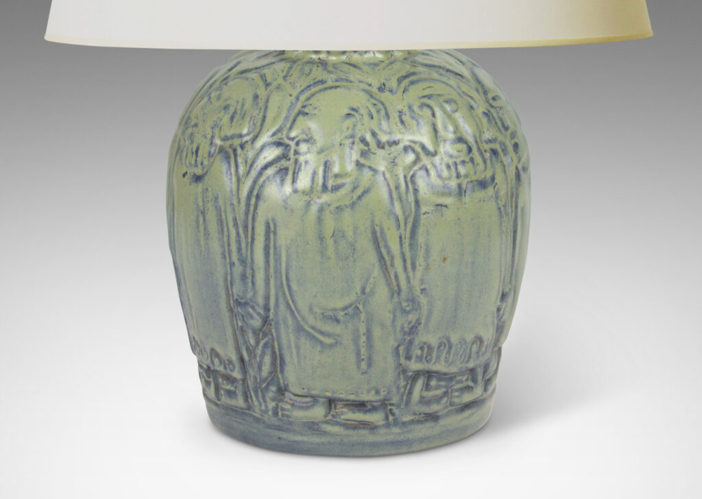 Gallery BAC tapered globe form surrounded in relief figures, possibly monks, glazed in dark and light blue tones