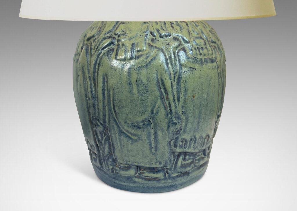 Gallery BAC tapered globe form surrounded in relief figures, possibly monks, glazed in dark and light blue tones