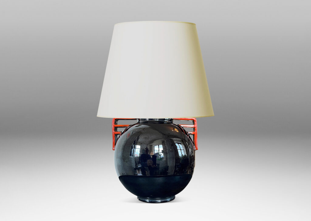 Gallery BAC globe form glazed in a gloss black with vermillion bracket handles