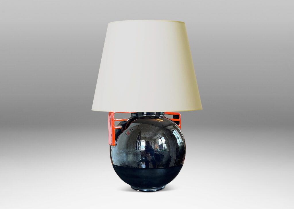 Gallery BAC globe form glazed in a gloss black with vermillion bracket handles