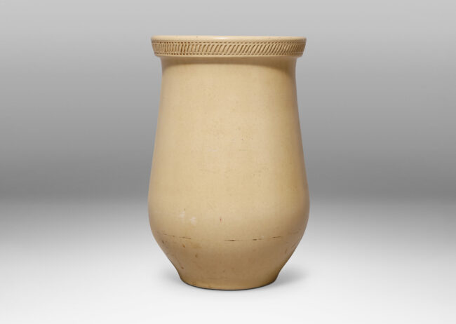 Gallery BAC wide tulip-like form with impressed pattern articulating a flared lip and an ivory glaze