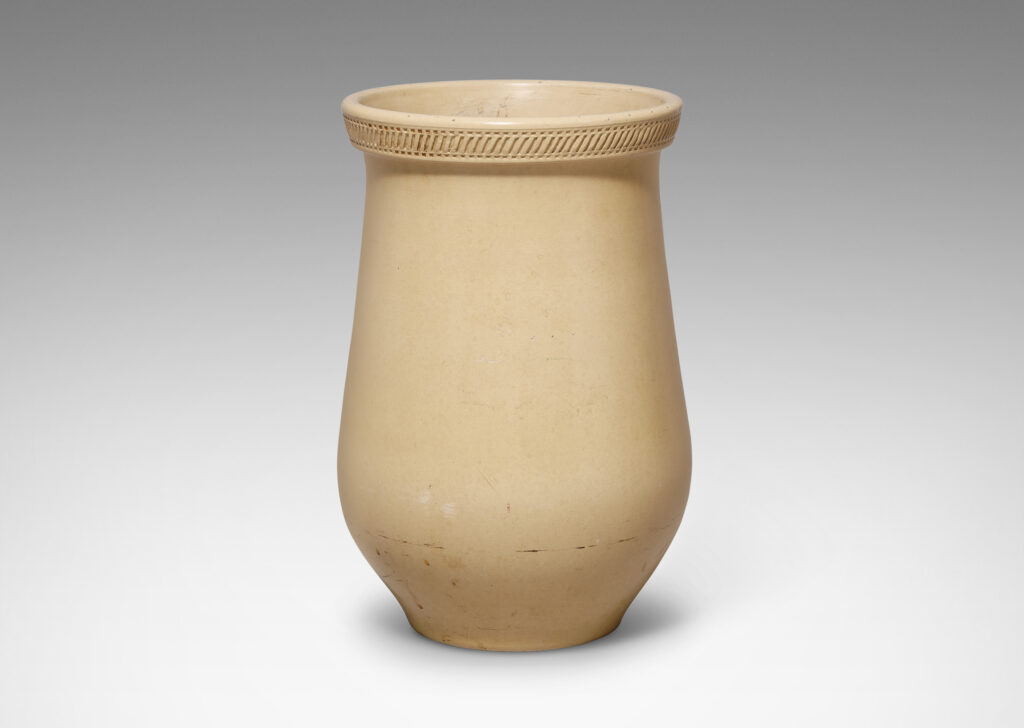 Gallery BAC wide tulip-like form with impressed pattern articulating a flared lip and an ivory glaze