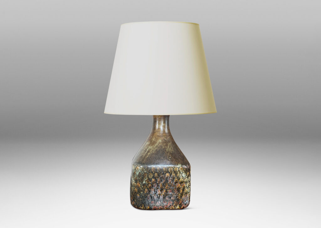 Gallery BAC square bottle-like form with rows of carved circle motifs and sprouting neck, glazed in a greenish-gray tone