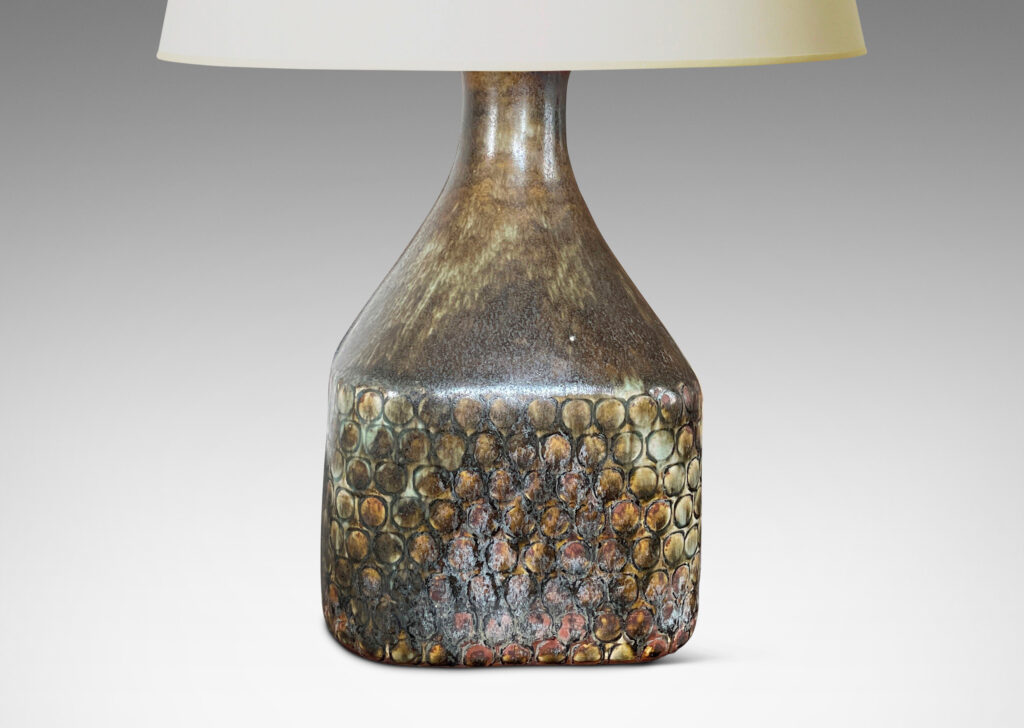 Gallery BAC square bottle-like form with rows of carved circle motifs and sprouting neck, glazed in a greenish-gray tone