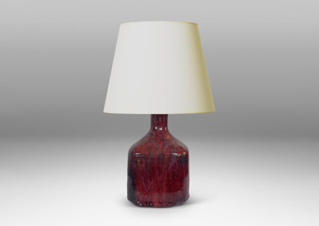 Gallery BAC square bottle-like form with rows of carved circle motifs and sprouting neck, glazed in a thick flowing burgundy-oxblood tone