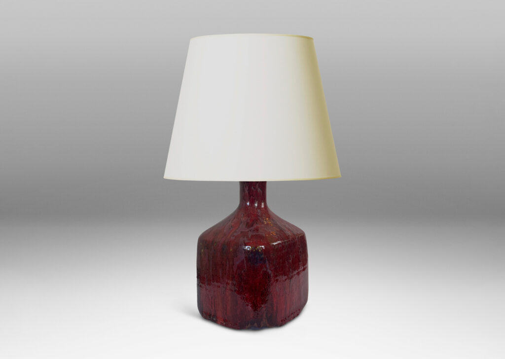 Gallery BAC square bottle-like form with rows of carved circle motifs and sprouting neck, glazed in a thick flowing burgundy-oxblood tone