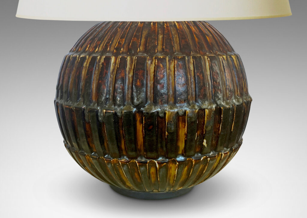 Gallery BAC globe form with rows of rectangular blocks in relief, glazed in a rare dark brown tone