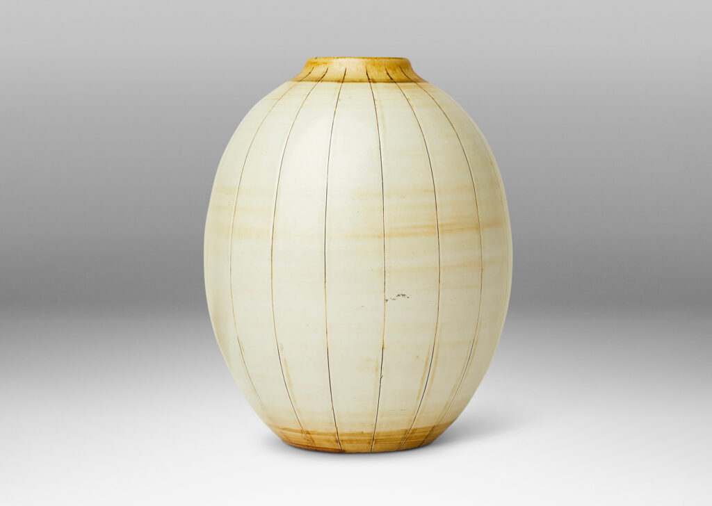 Gallery BAC arge ovoid form with carved meridians, glazed in ivory with light brown accents