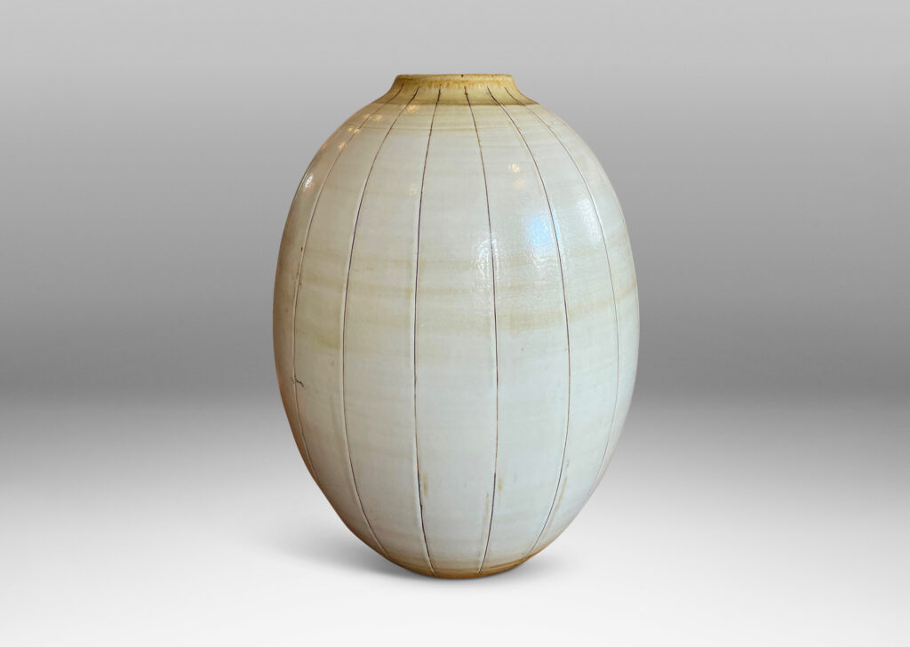 Gallery BAC arge ovoid form with carved meridians, glazed in ivory with light brown accents