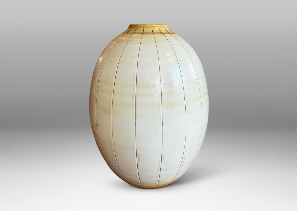 Gallery BAC arge ovoid form with carved meridians, glazed in ivory with light brown accents