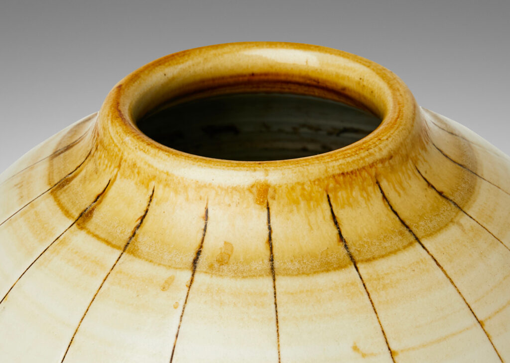 Gallery BAC arge ovoid form with carved meridians, glazed in ivory with light brown accents