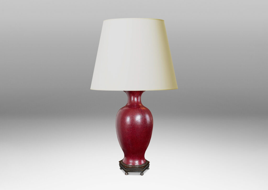 Gallery BAC elegant vase form glazed in a rich oxblood glaze with a subtle orange peel finish, mounted on an octagonal base