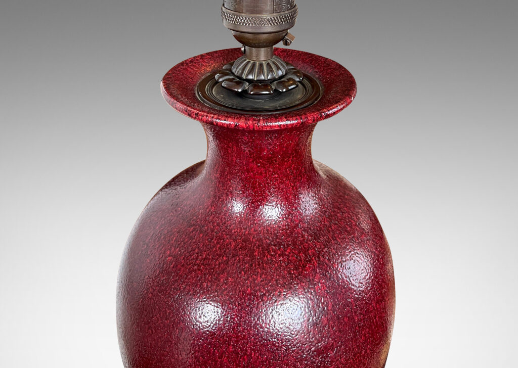 Gallery BAC elegant vase form glazed in a rich oxblood glaze with a subtle orange peel finish, mounted on an octagonal base