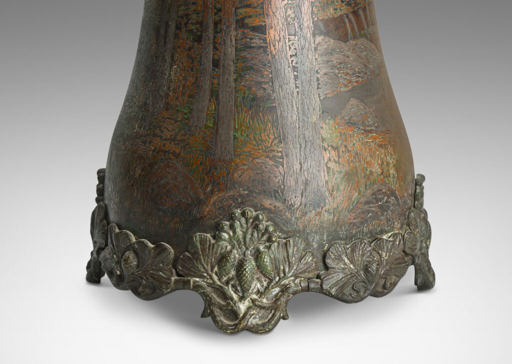 Gallery BAC tall undulating bell form with wonderfully detailed countryside scenes in low relief, with applied cast bottom edging decorated with pine boughs