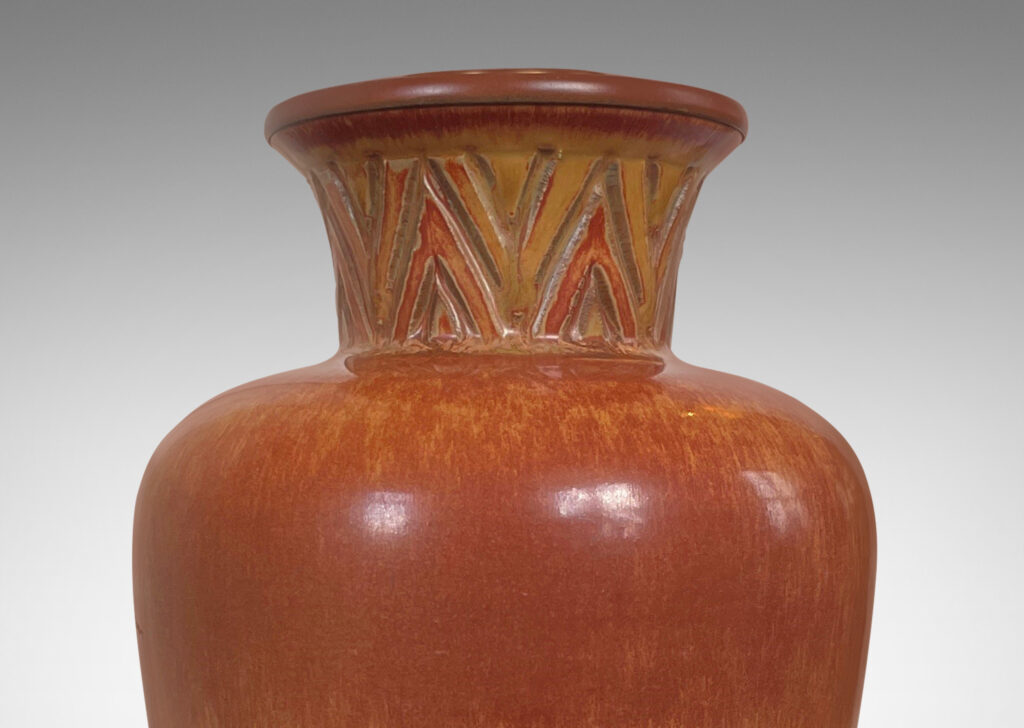 Gallery BAC tapered forms with flared necks carved with an Egyptian style chevron pattern, glazed in burnt sienna and butterscotch tones