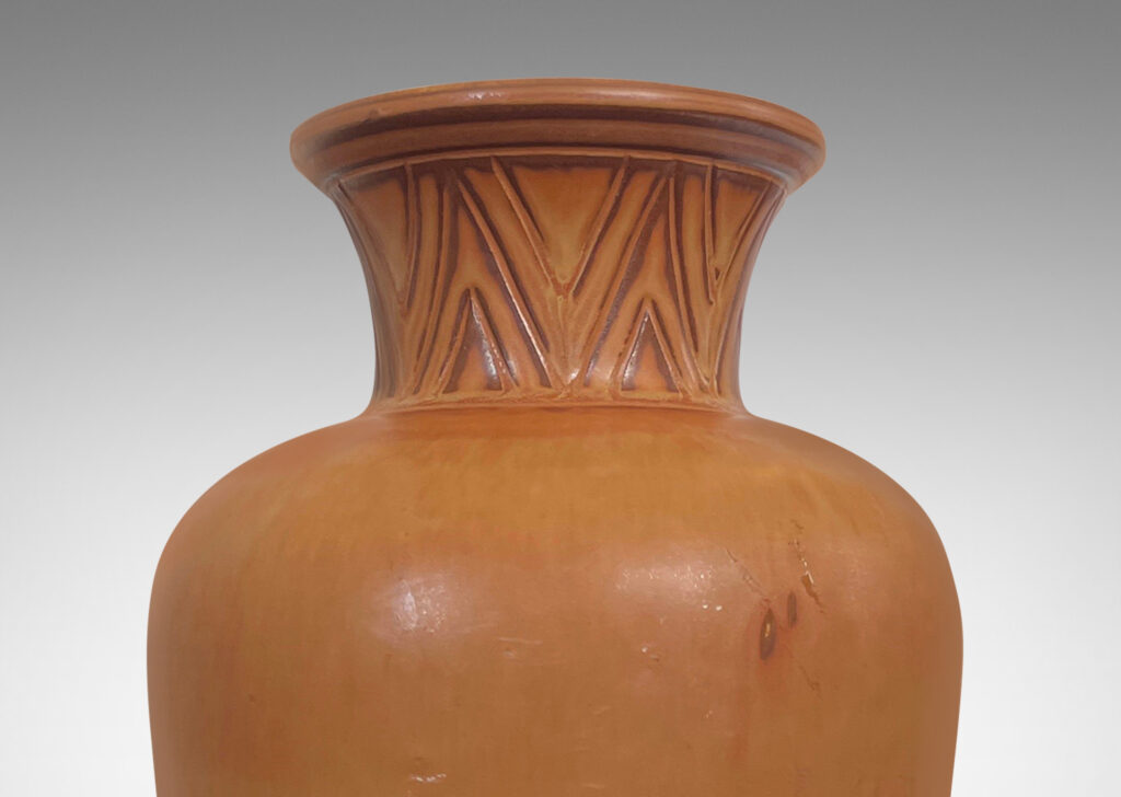 Gallery BAC tapered forms with flared necks carved with an Egyptian style chevron pattern, glazed in burnt sienna and butterscotch tones