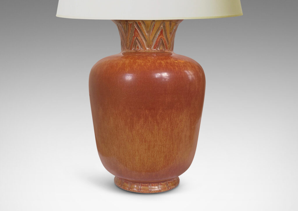 Gallery BAC tapered forms with flared necks carved with an Egyptian style chevron pattern, glazed in burnt sienna and butterscotch tones