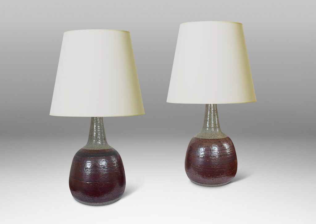 Gallery BAC bulbous forms with tall, conical necks, glazed in pale gray with burgundy luster