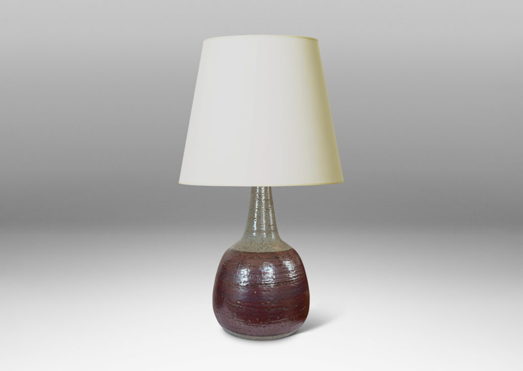 Gallery BAC bulbous forms with tall, conical necks, glazed in pale gray with burgundy luster