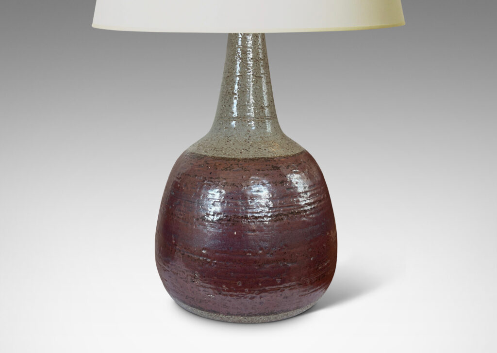 Gallery BAC bulbous forms with tall, conical necks, glazed in pale gray with burgundy luster