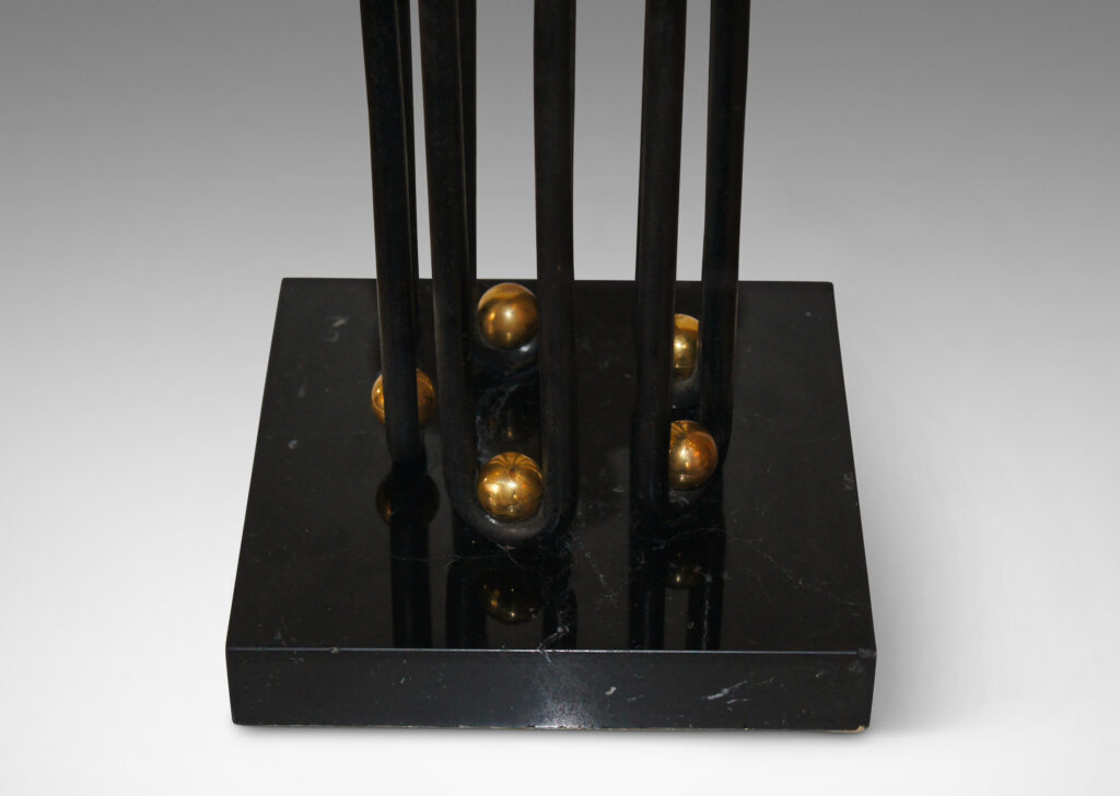 Gallery BAC bases formed by continuous waves in blackened wrought iron, punctuated by brass “boules” and mounted on square plinths in black marble