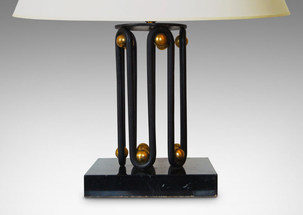 Gallery BAC bases formed by continuous waves in blackened wrought iron, punctuated by brass “boules” and mounted on square plinths in black marble