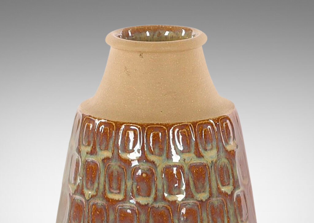 Gallery BAC swelling cylindrical form with impressed oblong motifs and cove neck, glazed in a flowing glossy iridescent beige-tinted clear glaze