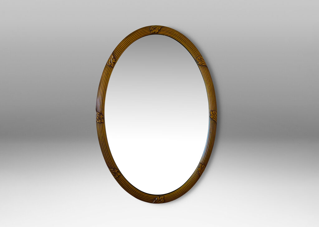 Gallery BAC oval form with reeded frame ornamented with scrolling leaf ornaments