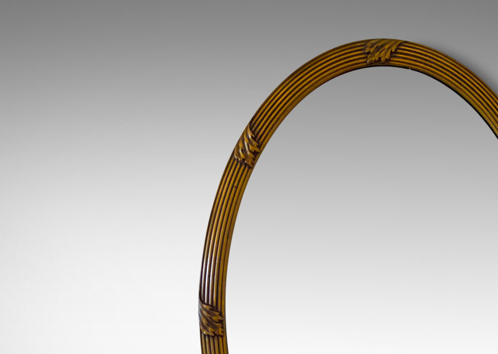 Gallery BAC oval form with reeded frame ornamented with scrolling leaf ornaments