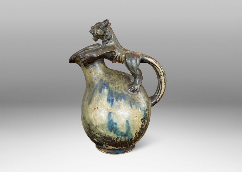 Gallery BAC aquamanile style pitcher form, with large lion forming the handle, glazed in a tan and brown