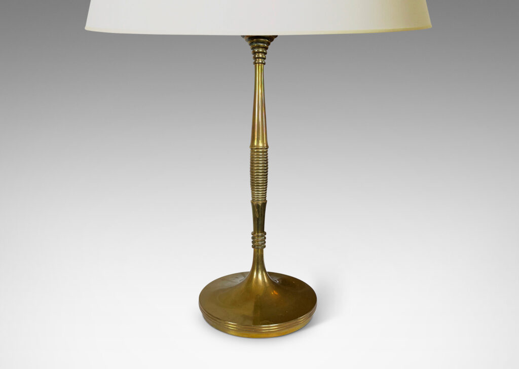 Gallery BAC swelling stand articulated with reeded and fluted bands springing from a disk base; cast brass