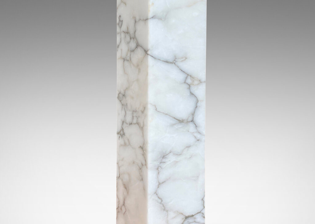 Gallery BAC having square pillar forms cut from solid marble in white with gray graining;