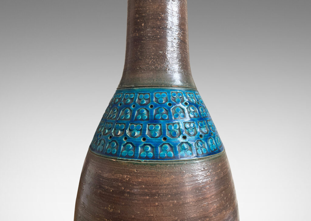 Gallery BAC tall ovoid body and long neck in a cool brown, with bands of impressed geometric patterns in a saturated cerulean blue