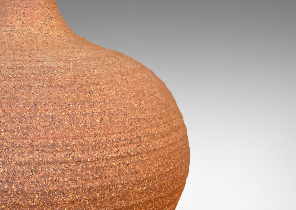 Gallery BAC ridged wide apple form with sprouting neck in an unglazed sandy-toned clay body